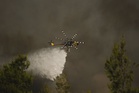 Helicopters collide in Greece as fires spread