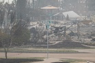 US Northwest battles wildfires after Spokane neighborhoods scorched