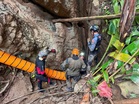Laos cave rescue: Four men carried out on stretchers, two remain missing after flash floods
