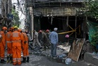 India detains hotel owner as probe begins into fire that left 21 dead amid scrutiny of safety standards