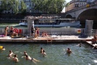 Parisians and tourists cool off with a swim in the Seine after record heatwave
