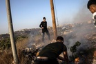 Palestinians report Israeli settlers set fire to two mosques amid surge in West Bank violence
