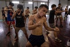 In Myanmar, where conflict rages, a brutal traditional boxing sport offers young fighters dignity and purpose