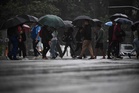 Umbrellas replace beach towels as Rio endures record-wet September