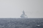 Chinese vessels surge around Philippine-held outposts in South China Sea
