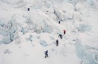 Photos show climbers attempting to scale Mount Everest despite increasing challenges