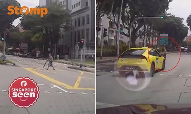 Elderly woman crosses road amidst busy traffic in Tampines, unfazed by close shave with car and taxi