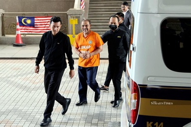 Optics of non-face blurring, handcuffed Jamil Khir’s grin in orange garb; UMNO grassroots fuming