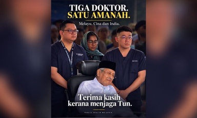 A deliberate choice? Three doctors of the major races quietly watch over Tun M