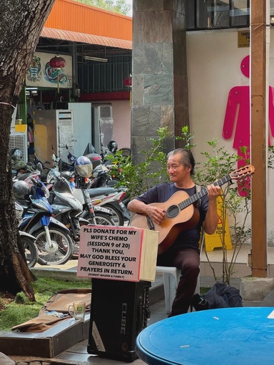 Penang uncle plays guitar at Batu Lanchang Market to raise funds for wife’s chemotherapy