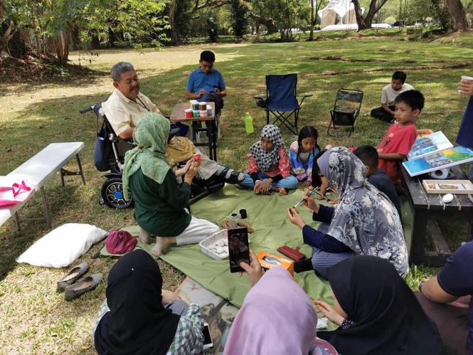 Image from: Deen an OKU once charged to be certified as one, now out on his motorised wheelchair teaching art #TheGoodOKU