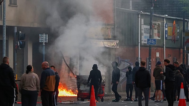 Cars and homes burn as unrest erupts in Belfast after knife attack