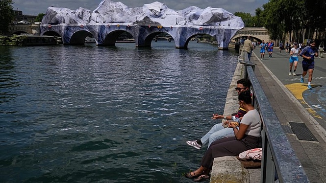 Crowds flock to JR's giant cave installation on Paris' Pont Neuf