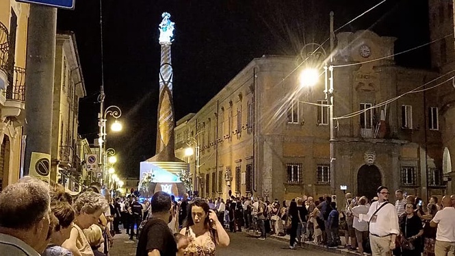 Italian town carries towering Virgin Mary structure through streets