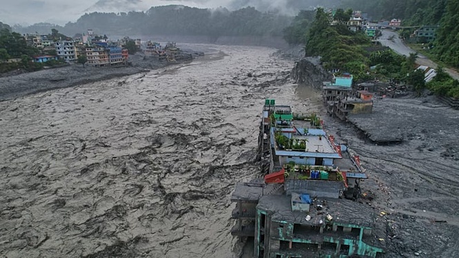 Authorities in Nepal carry out temporary burials of unidentified flood victims causing public outrage