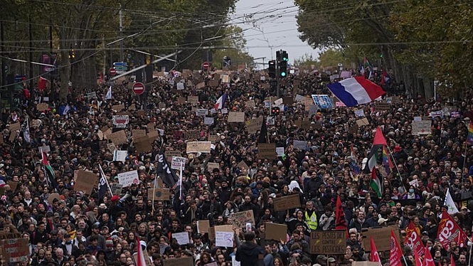 Clashes between French police and protesters after largely peaceful demonstrations that drew thousands