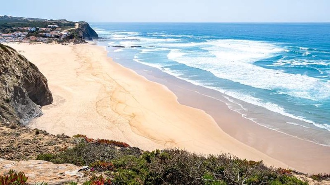 Image from: In Portugal, this beach nestled between cliffs and the Atlantic Ocean has just been voted the best in Europe