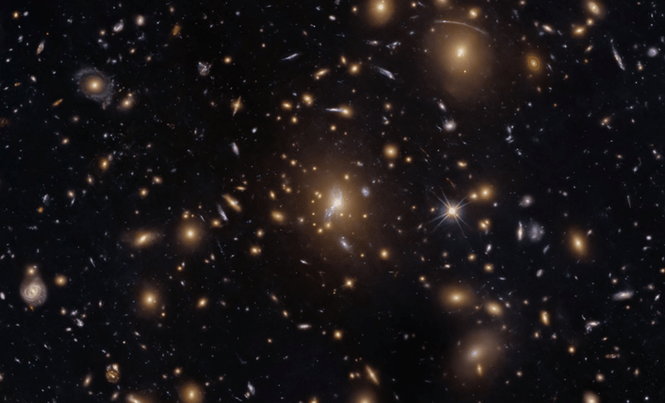 Image from: Hubble Captures A Cosmic Swarm That Is Bending Light Across The Universe
