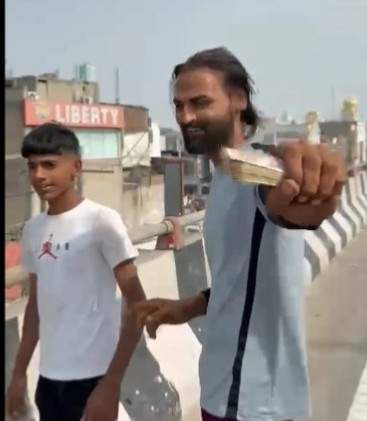 Image from: Money rains down on Panipat road: Man booked for throwing cash from flyover in Haryana to record viral reel