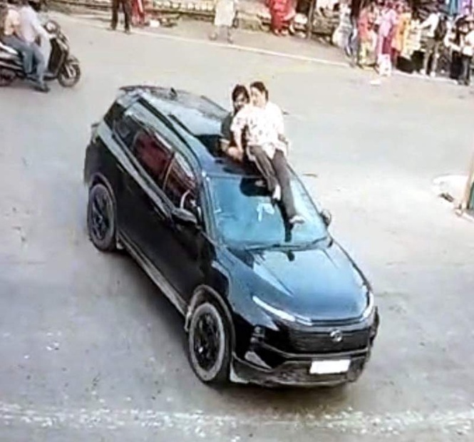 Image from: Couple booked for dangerous stunt on moving SUV in Himachal’s Dehra