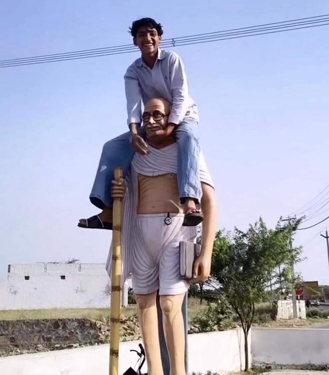 Image from: Video of youths atop Gandhi’s statue in Nuh sparks outrage, police launch hunt