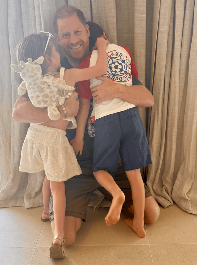 Image from: Meghan shares new photo of her children in tribute to Harry as Archie pictured wearing England top
