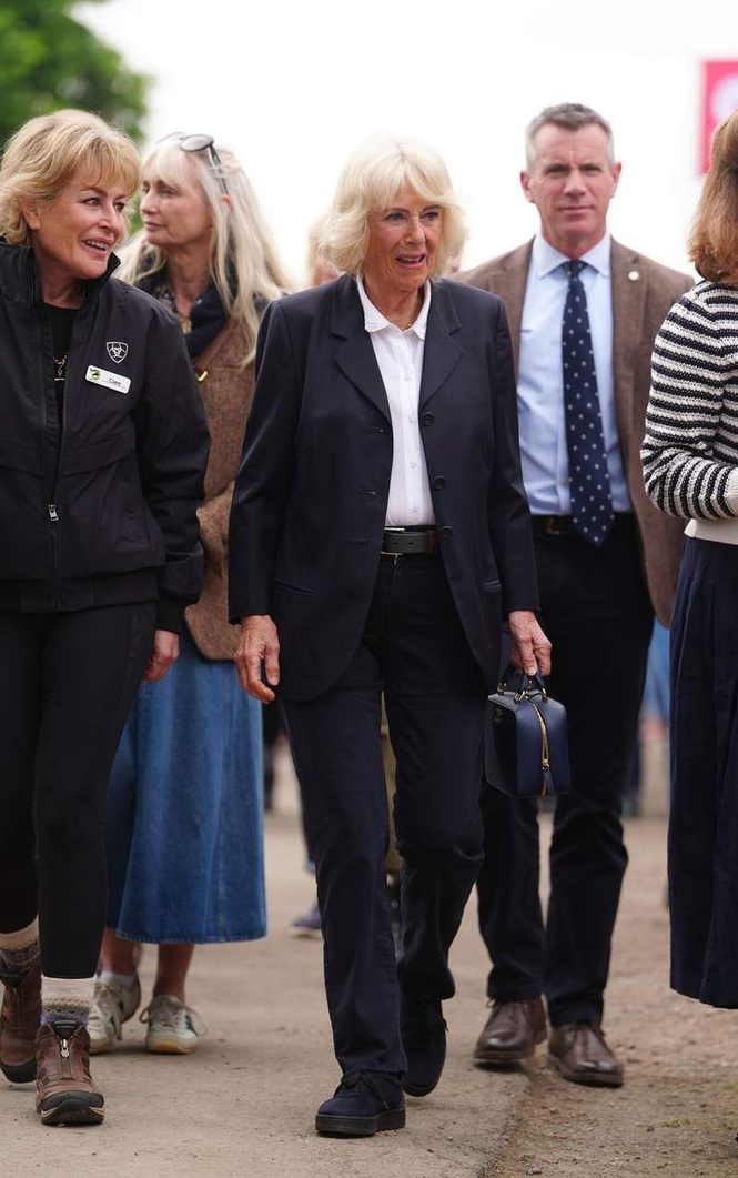 Image from: Queen Camilla breaks tradition as she swaps dresses for trousers