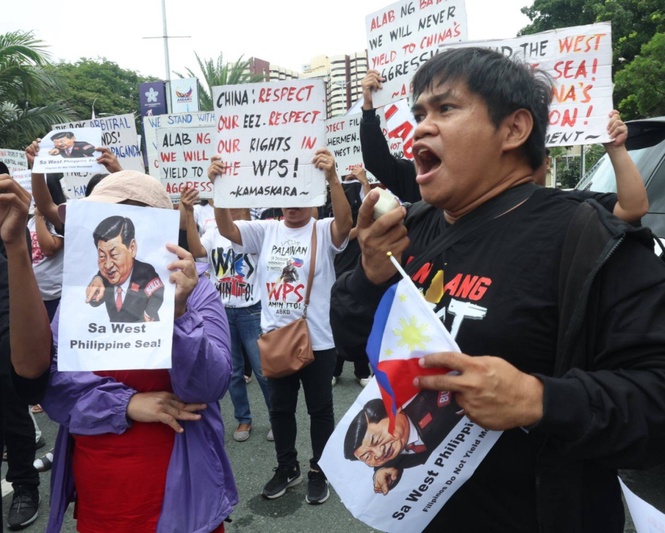 Protesters tell China's foreign minister: Apologize over racist AI video, stop WPS aggression