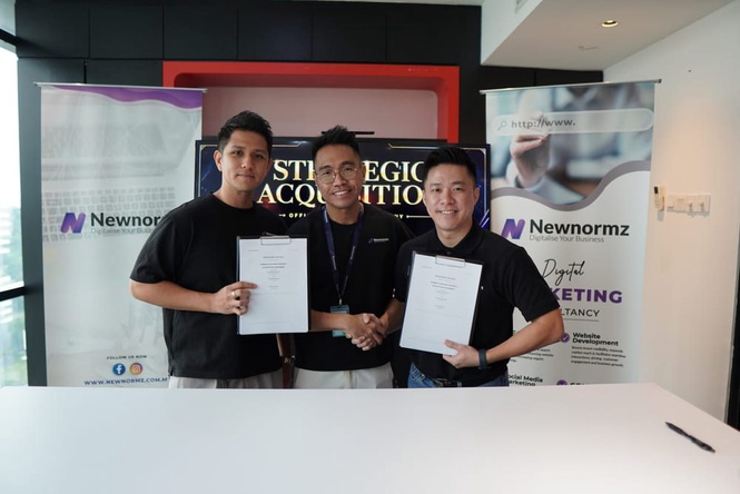 Newnormz and Weitzen representatives holding signed documents after completing the strategic acquisition agreement.