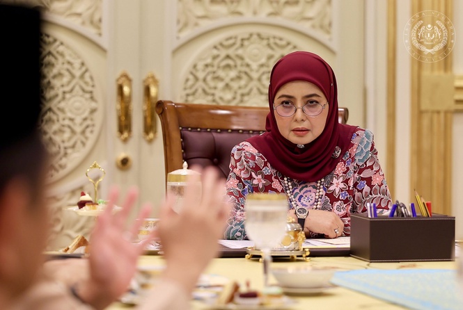 May be an image of one or more people, headscarf and text