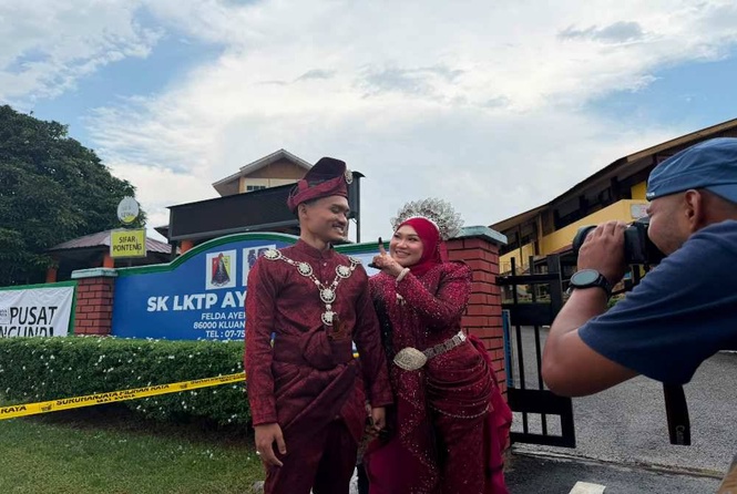 Image from: Newlyweds make voting part of their wedding day memories in Johor polls