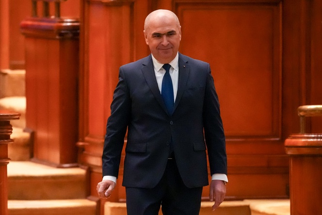 Romania's prime minister fights for survival as no-confidence motion is debated in Parliament