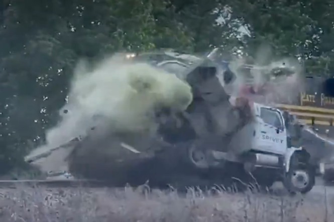 Sewage tank explodes after train smashes into truck in dramatic video