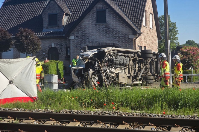 Several hurt in a crash between a train and a minibus, Belgian police say