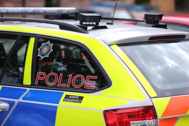 Man held on suspicion of attempted murder after police car driven at officer