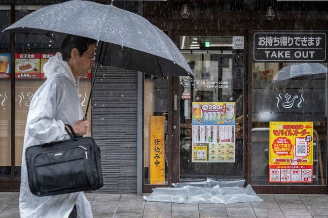 Typhoon Jangmi slams into Japan with heavy rain, flood warnings and travel chaos