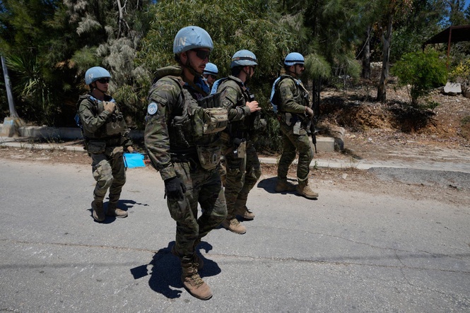 Photos show Lebanese and UN troops take positions in a village vacated by Israeli soldiers