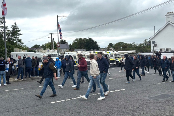 DUP MP defends photo with masked men at Scarva protest
