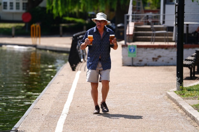 UK records hottest June temperature for third day as heatwave warnings issued