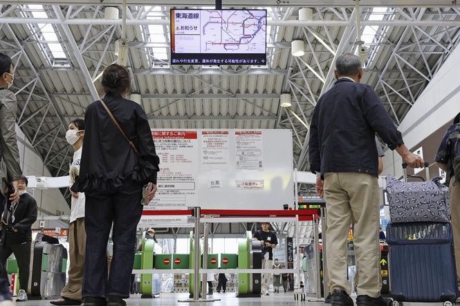 Heavy rain pounds western Japan as 2 tropical storms approach