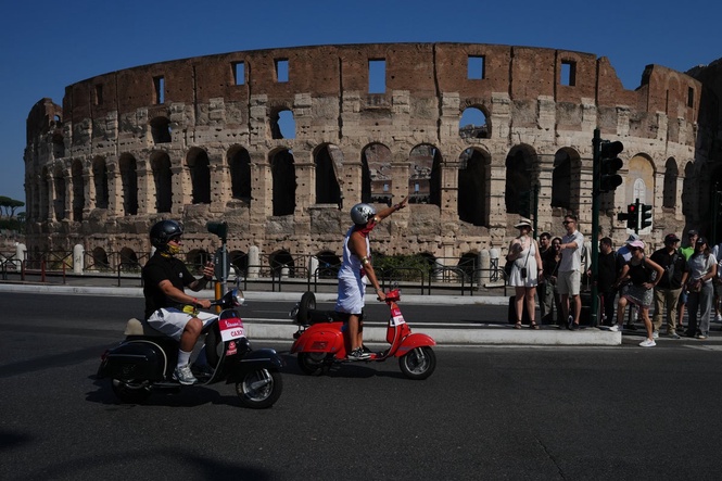 Photos show Vespa enthusiasts buzzing through Rome celebrating the little scooter's 80th anniversary