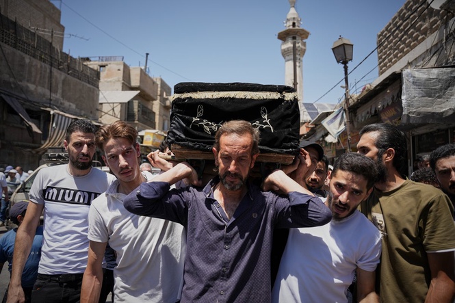 Mourners in Damascus bury cafe blast victims as officials promise justice