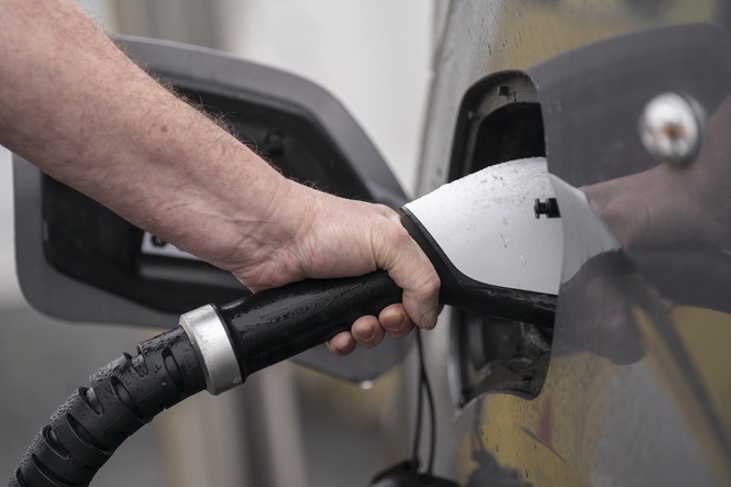 What is the new pay-per-mile tax for electric vehicles and how will it work?