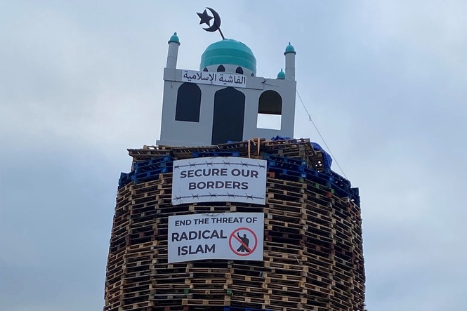 Police urged to act after replica of mosque placed on top of loyalist bonfire