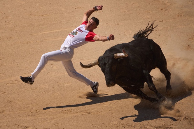 Runner gored in face and at least 12 others injured during Spain’s historic bull run festival