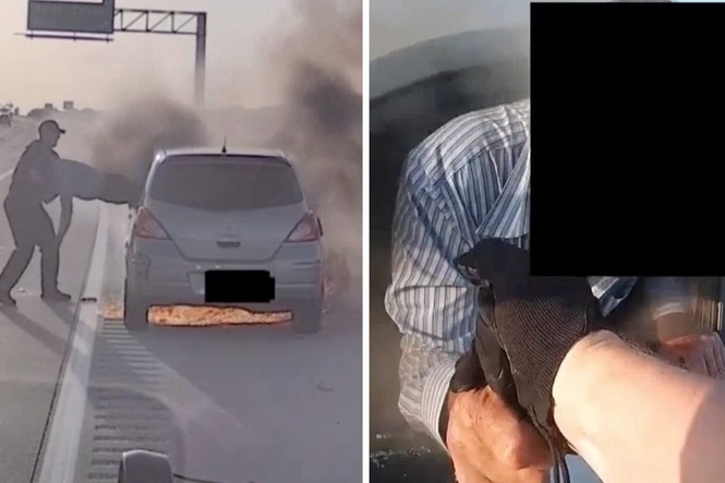Cop drags motorist out of smoking car as it bursts into flames on side of the highway