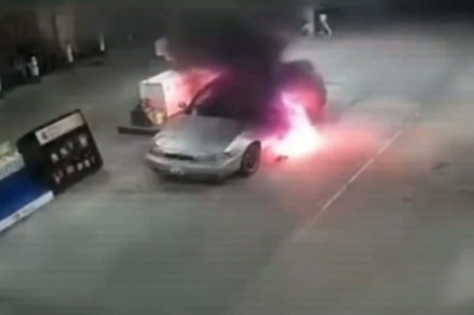 Driver and passenger flee through flames as car erupts into fireball at petrol pump