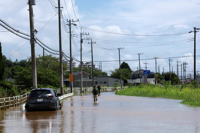Eight dead and 230,000 evacuated as flooding hits Japan