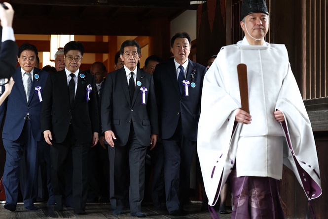 Japan PM stays away from shrine to WWII dead but defence minister’s visit angers neighbours