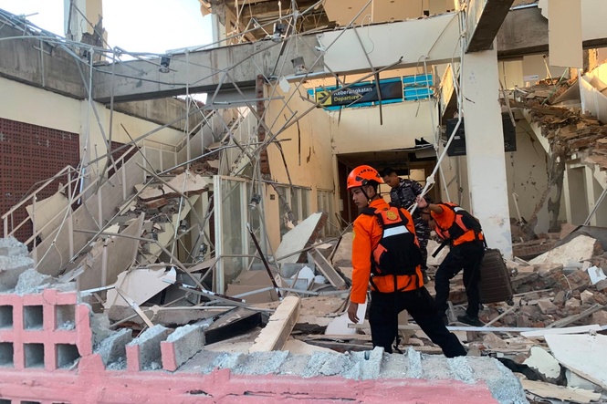 Rescuers dig through rubble and landslides after Indonesia quake kills 47